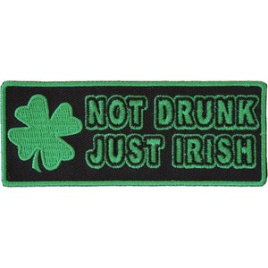 May include: Green embroidered patch with a four-leaf clover and the text "NOT DRUNK JUST IRISH".
