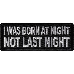 May include: Black embroidered patch with white text that reads "I was born at night not last night".