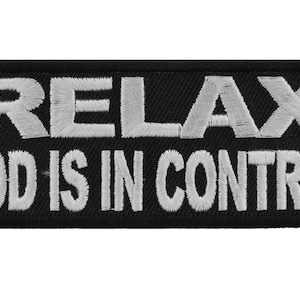 May include: Black embroidered patch with white text that reads "Relax God is in Control".