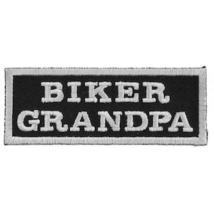 May include: Black and white embroidered patch with the text "Biker Grandpa" in a white font.