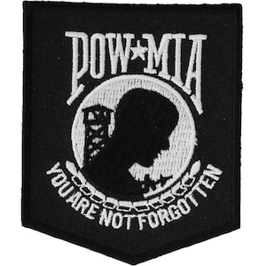 May include: Black and white embroidered patch with a silhouette of a soldier's head in profile, surrounded by a wreath and the words "POW*MIA YOU ARE NOT FORGOTTEN".