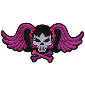 May include: Embroidered patch featuring a skull with pigtails and wings. The skull is gray with black eyes and a pink mouth. The wings are pink and purple. The pigtails are pink with pink bows.