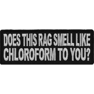May include: Black embroidered patch with white text that reads "Does this rag smell like chloroform to you?"