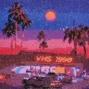 May include: A diamond painting of a sunset scene with palm trees and a sign that reads "VHS is back". The painting is made up of small, colorful diamonds.