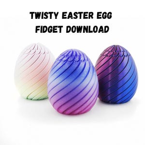 May include: Three twisty Easter eggs in pastel shades. The eggs feature a spiral design and are in pink, purple, and blue. The image includes the text "TWISTY EASTER EGG FIDGET DOWNLOAD" at the top.