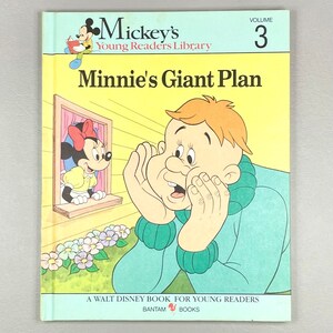 May include: A vintage children's book cover featuring Mickey Mouse and Minnie Mouse. The title is "Minnie's Giant Plan" and the book is volume 3 of Mickey's Young Readers Library. The cover is illustrated with Minnie Mouse looking out a window and a surprised character with his hands cupped around his ears.