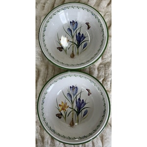 May include: Two white ceramic bowls with green trim and a floral design featuring purple and yellow crocuses and butterflies.