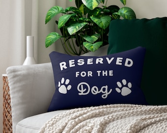 May include: A navy blue throw pillow with white paw prints and the text "RESERVED FOR THE Dog" in white.