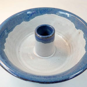 May include: A set of three ceramic mugs with a speckled, matte finish. The mugs are in shades of cream, light gray, and dark gray. Each mug has a simple, minimalist design, perfect for coffee or tea.