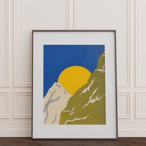 May include: A framed print of a minimalist mountain landscape with a yellow sun and blue sky. The mountains are green and white.