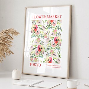 May include: Framed art print featuring a watercolor floral pattern. The print displays a repeating pattern of pink, red, and white flowers with green leaves against a white background. The words "FLOWER MARKET TOKYO" are printed in red at the top and bottom.