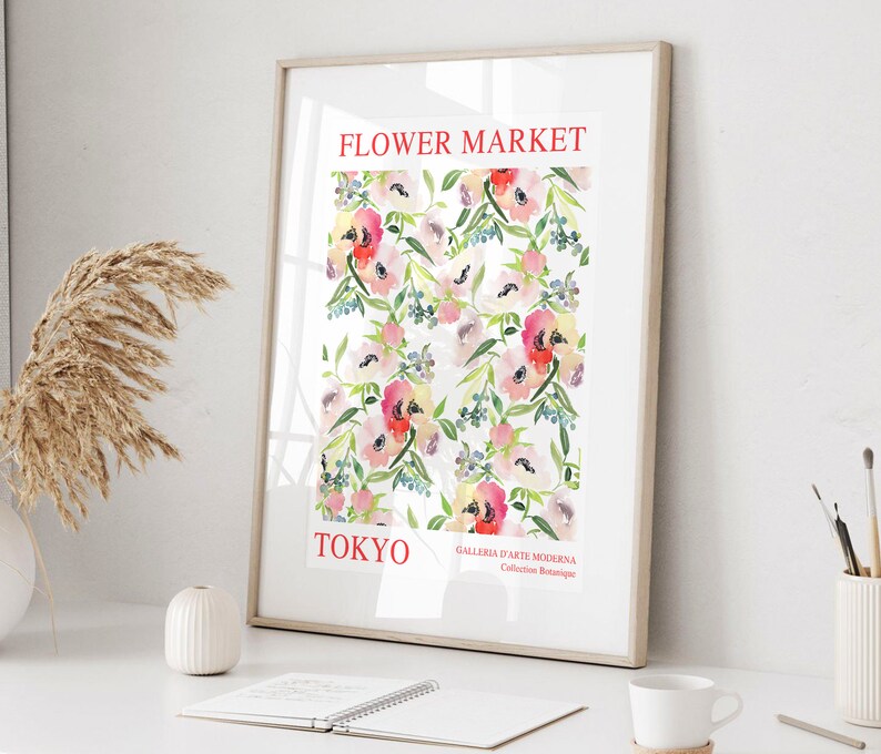 May include: Framed art print featuring a watercolor floral pattern. The print displays a repeating pattern of pink, red, and white flowers with green leaves against a white background. The words "FLOWER MARKET TOKYO" are printed in red at the top and bottom.