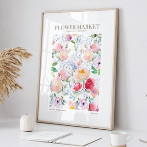 May include: Framed floral art print featuring a watercolor design of pink, red, and purple flowers with green leaves and blue accents. The print is titled "Flower Market" with text that reads "Collection Botanique" and "Galerie d'Art Modern, New York."