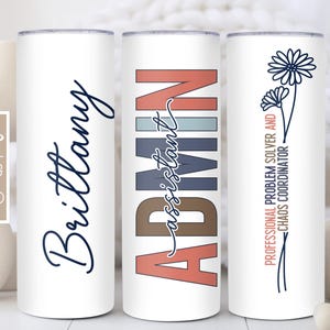 May include: Three white tumblers with different designs. The first tumbler has the name "Brittany" written in black cursive. The second tumbler has the word "ADMIN" written in colorful block letters with the word "assistant" written in cursive underneath. The third tumbler has the text "Professional Problem Solver and Chaos Coordinator" written in black cursive.
