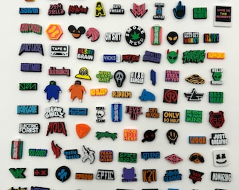 May include: A collection of colorful, square-shaped charms with various music-related words and logos. The charms are made of a soft, rubbery material and are perfect for adding a personal touch to your belongings.