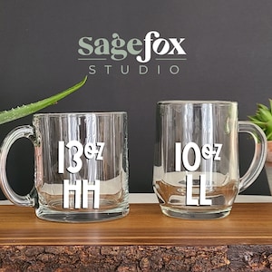 May include: Two clear glass mugs with black lettering. The mug on the left says "13 oz HH" and the mug on the right says "10 oz LL".