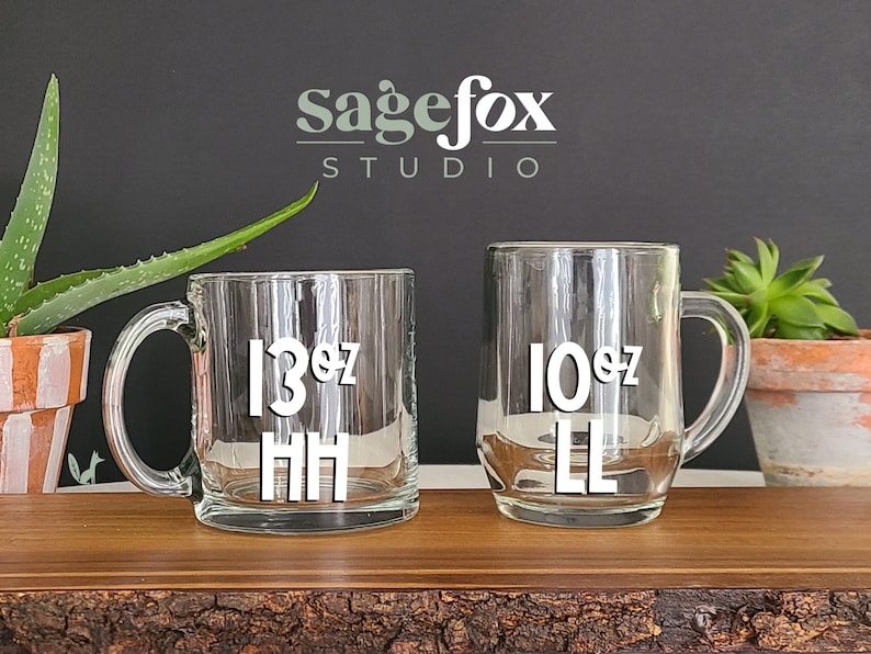 May include: Two clear glass mugs with black lettering. The mug on the left says "13 oz HH" and the mug on the right says "10 oz LL".