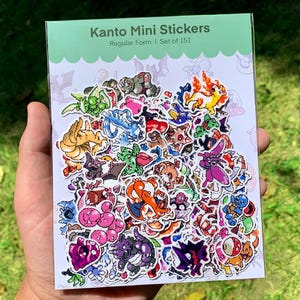 May include: A pack of Kanto Mini Stickers, Regular Form, Set of 151, with colourful cartoon characters. The stickers are on a white background with a green border. The pack is held in a hand against a blurred green background.