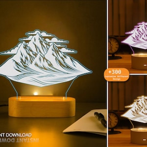 May include: A 3D printed night light with a mountain range design. The light is on a wooden base and is illuminated with a warm white light. The image also shows a text overlay that says " +300 Customize Different Design".