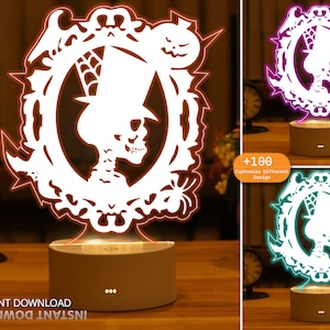 May include: A white 3D printed design of a skeleton wearing a top hat and surrounded by Halloween-themed imagery. The design is illuminated by a colorful LED light base. The base has three buttons on the front. The image shows three different color options for the light base: orange, purple, and teal.