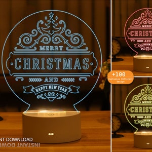 May include: A white LED night light with a clear acrylic panel featuring a stylised design of a Christmas tree and the text "Merry Christmas and Happy New Year". The light is on a white base with three small black dots.