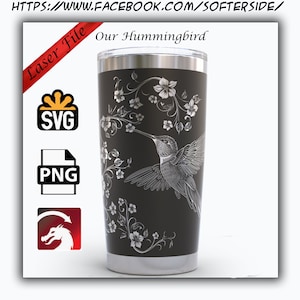 May include: A stainless steel tumbler with a black powder coat finish. The tumbler features a laser engraved design of a hummingbird in flight with floral accents. The text "Our Hummingbird" is printed on the tumbler.