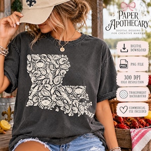May include: A charcoal grey t-shirt featuring a cream-coloured graphic of the state of Louisiana filled with illustrations of seafood including crabs, crawfish, shrimp, and oysters. The text Paper Apothecary Digital Designs for Creative Makers is visible.