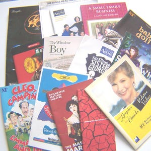 May include: A selection of theatre playbills and programmes, showcasing diverse titles and cover designs. The covers feature images of actors, illustrations, and text, including "The Winslow Boy," "Relative Values," and "Cleo Camping."