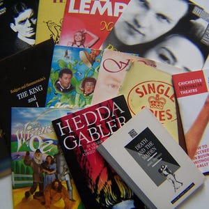 May include: A selection of theatre programmes and books, showcasing diverse covers. The covers feature actors, illustrations, and text, including "The King and I" and "Hedda Gabler". A variety of colours are visible.