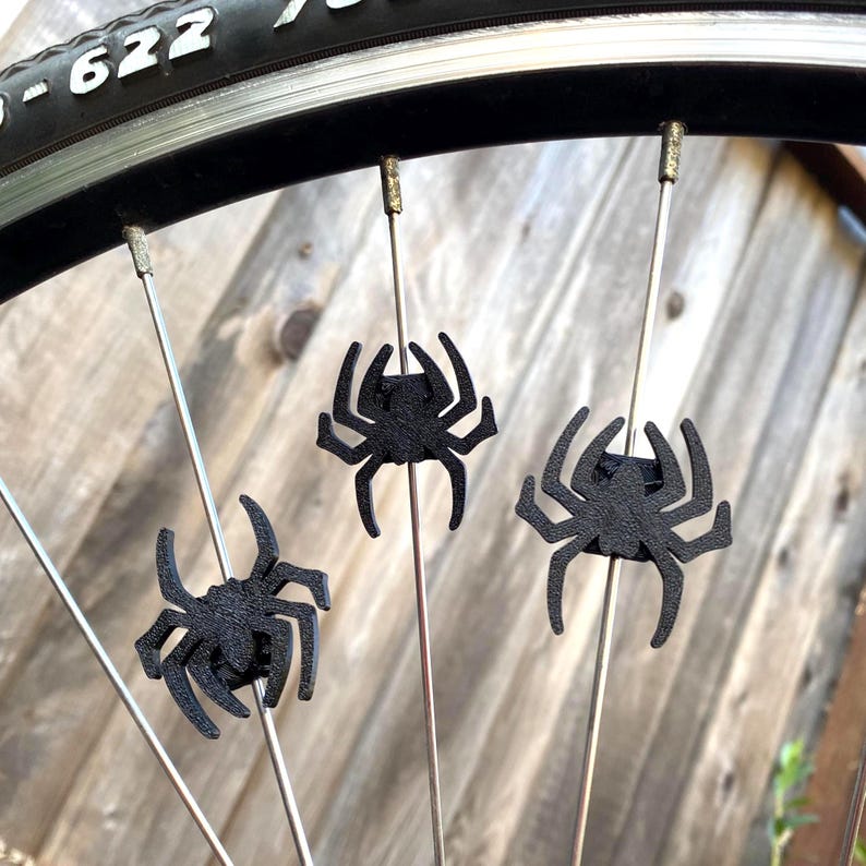 spider themed bike decorations on a bicycle wheel