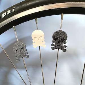 pirate skull themed bike spoke decorations on a bicycle wheel