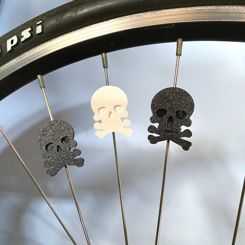 pirate skull themed bike spoke decorations on a bicycle wheel