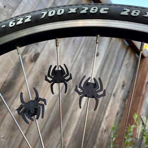 spider themed bike spoke decorations on a bicycle wheel