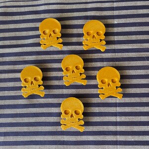 gold pirate skull themed bike decorations on a bicycle wheel