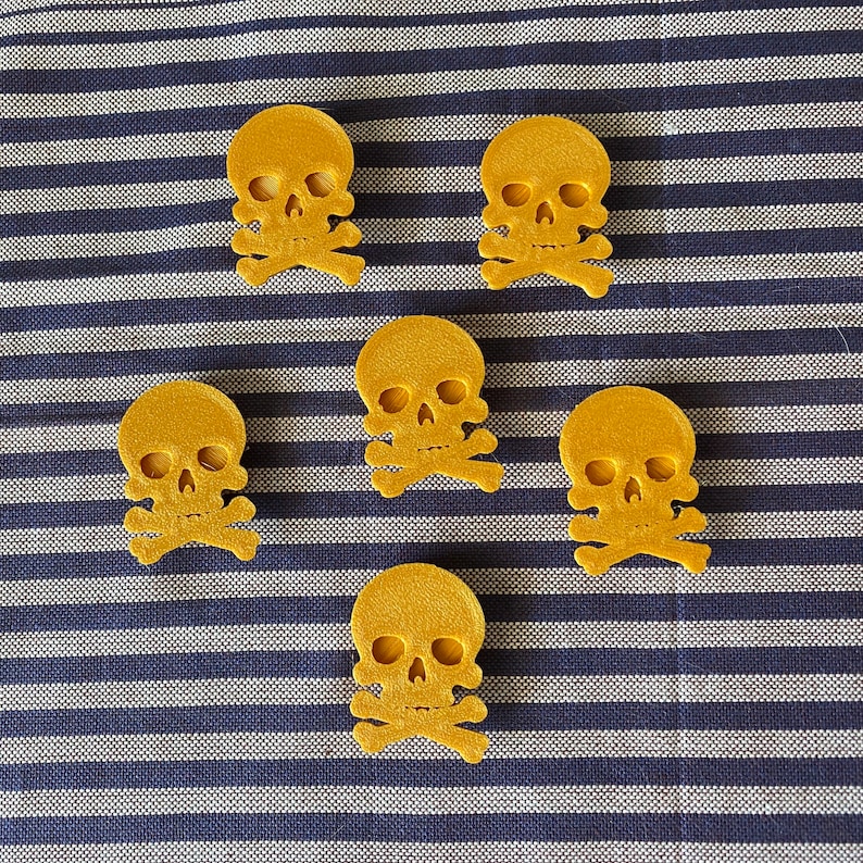 gold pirate skull themed bike decorations on a bicycle wheel