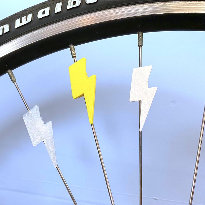 Lightning bolt bike decorations on the spokes of a bicycle wheel