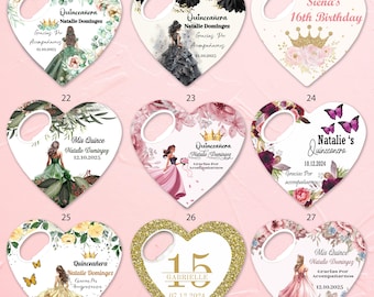 May include: A collection of nine heart-shaped bottle openers featuring various designs, including illustrations of individuals in gowns, floral patterns, crowns, and butterflies, with printed text such as Quinceañera, names, and dates.