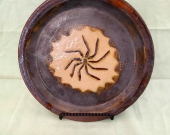 Ceramic plate with circular symbol