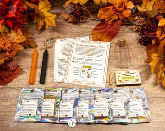 May include: Samhain Spell Kit with a clear glass jar, black and orange candles, a matchbox, and seven small bags of herbs labeled: Black Tourmaline, Rosemary, Mugwort, Sea Salt, Cinnamon, Sage, and Calendula. The kit also includes instructions for a Samhain spell.