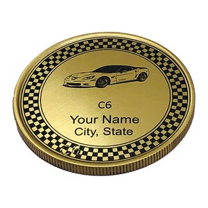 May include: Gold-colored coin with a black and white checkered border. The center features a black and white image of a Corvette C6 with the text "C6 Your Name City, State".