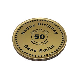 May include: Gold-colored coin with a black inscription that reads "Happy Birthday" with a star border. The coin also has a black circle with the number "50" inside, and the text "August 31, 1972" and "August 31, 2022" below the circle. The text "Gene Smith" is inscribed below the circle.