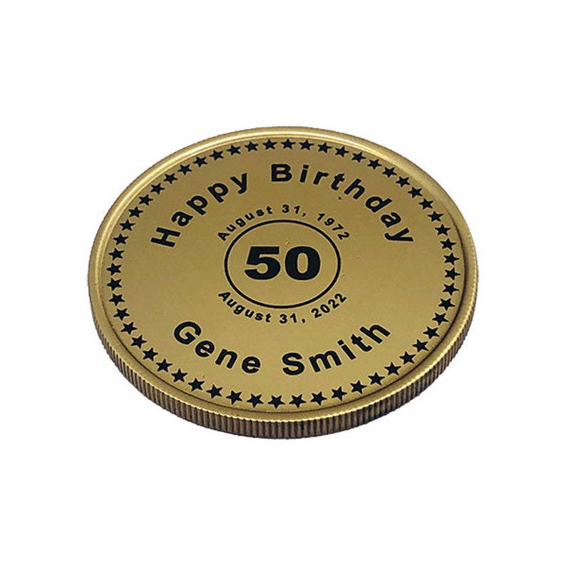 May include: Gold-colored coin with a black inscription that reads "Happy Birthday" with a star border. The coin also has a black circle with the number "50" inside, and the text "August 31, 1972" and "August 31, 2022" below the circle. The text "Gene Smith" is inscribed below the circle.
