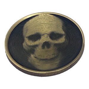 May include: A gold-colored coin with a black and gold skull design. The skull is created with concentric circles.