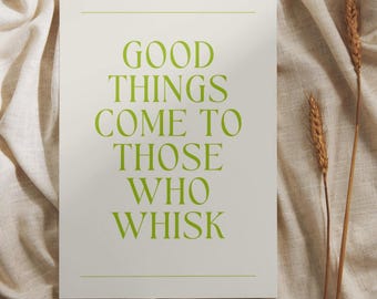 May include: A rectangular print with the text "GOOD THINGS COME TO THOSE WHO WHISK" in green. The print is on a cream-colored background with two stalks of wheat. The background is a textured, cream-colored fabric.