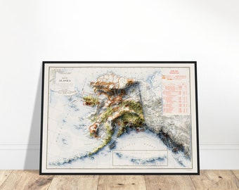May include: Framed vintage map of Alaska, featuring detailed topographical relief in shades of brown, green, and gray. The map includes the text "Map of Alaska" and is set against a white background. The frame is black.