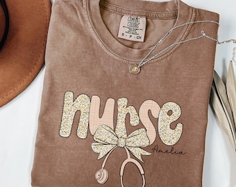 Comfort Colors® Floral Nurse Shirt, Cute RN Tee With Bow, Custom Nursing School Shirt, Registered Nurse Gift, New Nurse Grad Appreciation