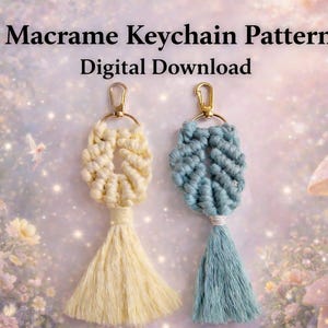 May include: Two macrame keychains, one cream and one dusty blue, each featuring a knotted loop design and a tassel, attached to a gold-tone metal lobster clasp. The text Macrame Keychain Pattern Digital Download is centred above the keychains.