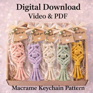 May include: A collection of five macrame keychains in a box, each in a different pastel color: peach, lavender, cream, mint green, and yellow. Each keychain is adorned with a gold-colored ring and a small tag that says "Thank you". The text "Digital Download Video & PDF" and "Macrame Keychain Pattern" are also visible.