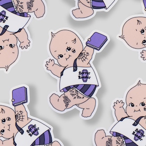 May include: A sticker sheet featuring multiple stickers of a baby-like figure with tattoos, wearing a bib that says "Horror Reader" and purple striped diaper. The baby is holding a purple book.