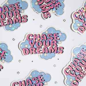 May include: A set of six iridescent stickers with a cloud design and the text "Chase Your Dreams". The stickers have a holographic finish and are decorated with small stars.